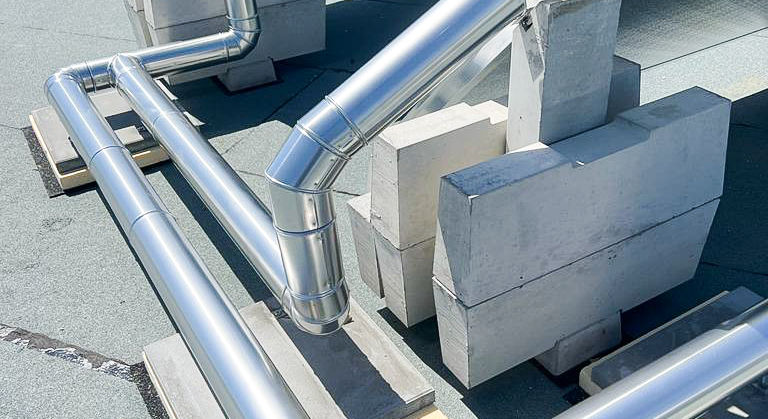 Metal-clad pipework on the roof