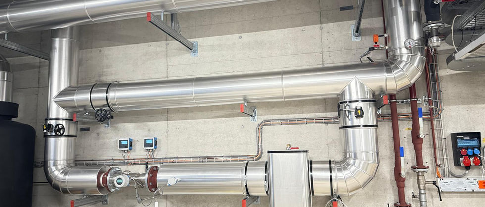 Polished metal cladding over insulated pipework – clean finish